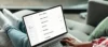 Person using a laptop to access a GoDaddy account dashboard. The screen displays a list of services including Websites + Marketing, Commerce & Payments, Managed WordPress, Email & Office, and SSL Certificates.
