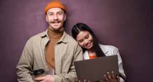 man and woman looking at laptop